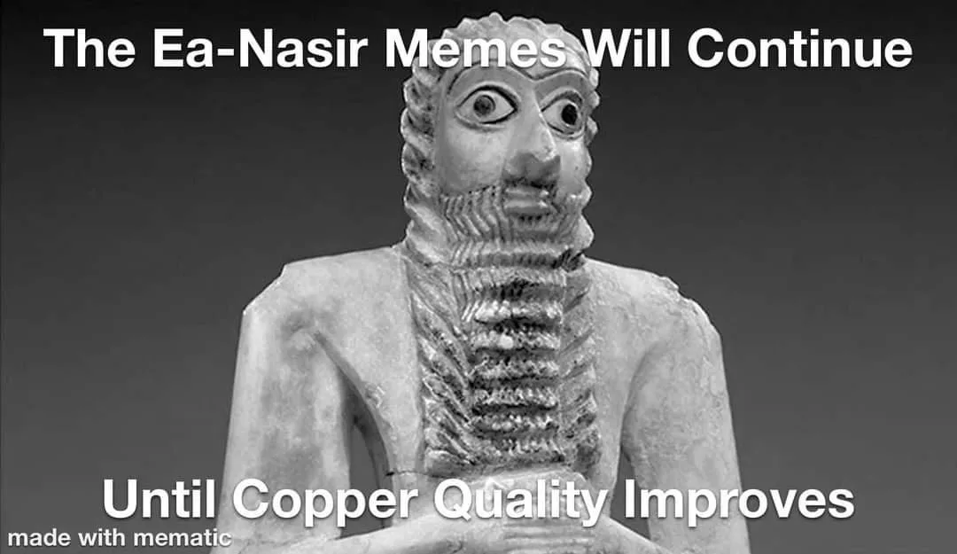 A black-and-white image of an ancient Mesopotamian statue, likely Ea-Nasir, with a stylized beard and large, expressive…