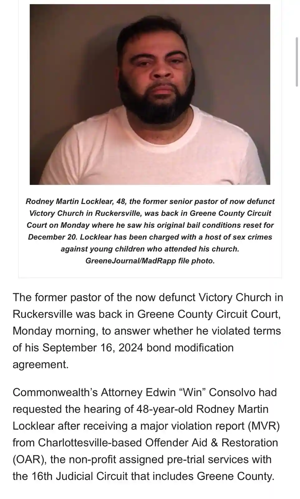 A mugshot-style photo of a man with a beard wearing a white t-shirt. Below the photo is a news caption identifying him as…