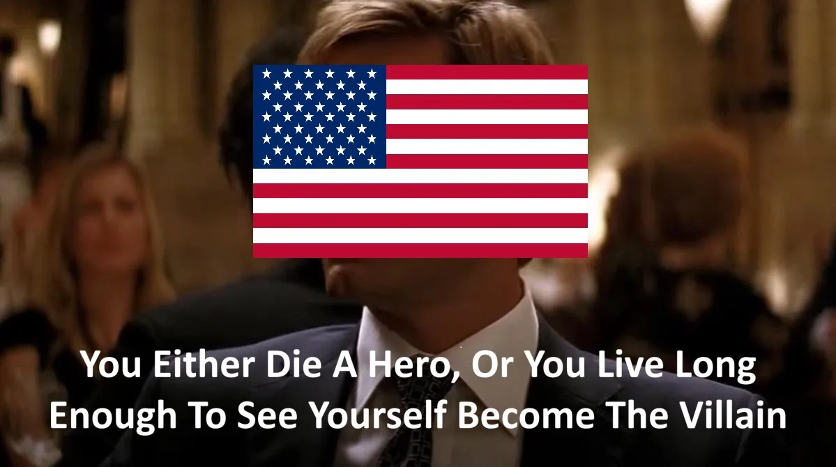 A man in a suit and tie has an American flag superimposed over his face, obscuring his identity. Below him, white text…