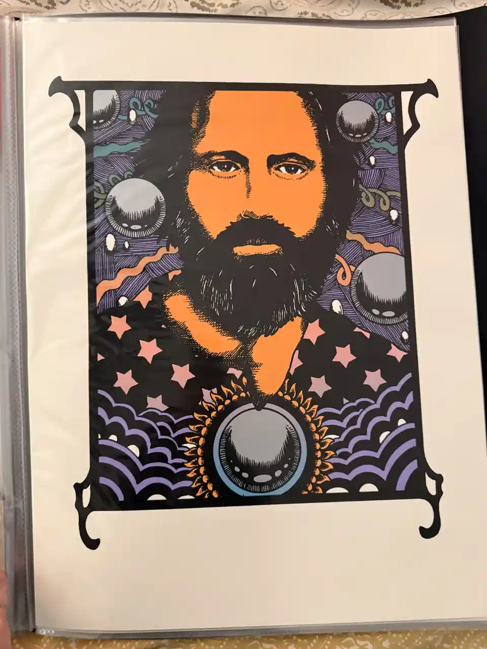 A stylized, psychedelic print of a bearded man with an orange face and black beard, framed in an ornate black border. The…