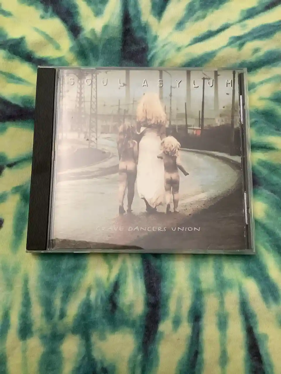 A CD case for the album 'Soul Asylum' by Grave Dancers Union, featuring a sepia-toned photo of a woman in a white dress…