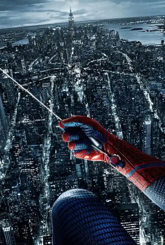 A close-up shot of Spider-Man's gloved hand firing a web against a dark, illuminated cityscape at night, with the Empire…