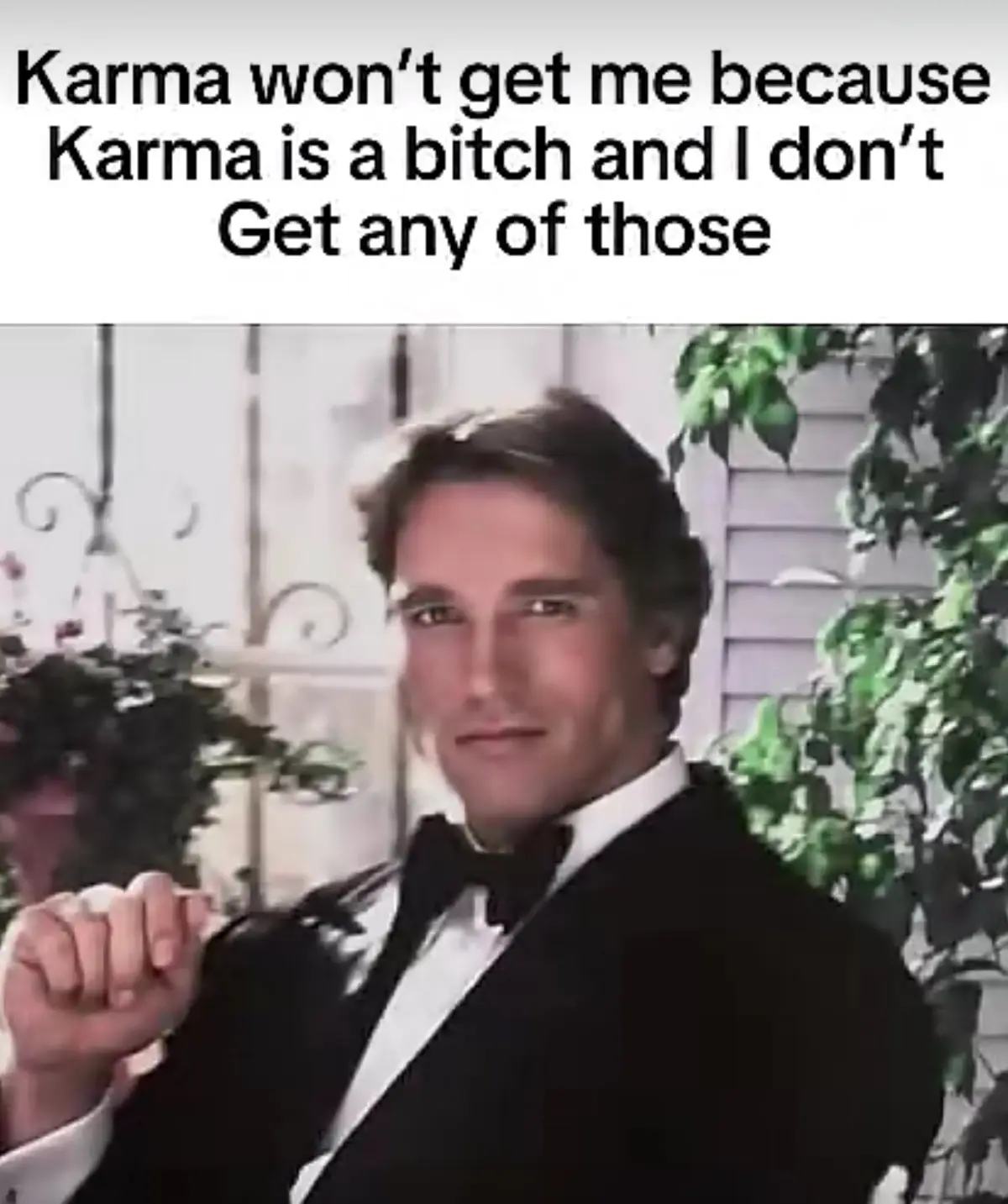 A man in a black tuxedo and bowtie points confidently at the viewer with a smug expression. The overlaid text reads 'Karma…