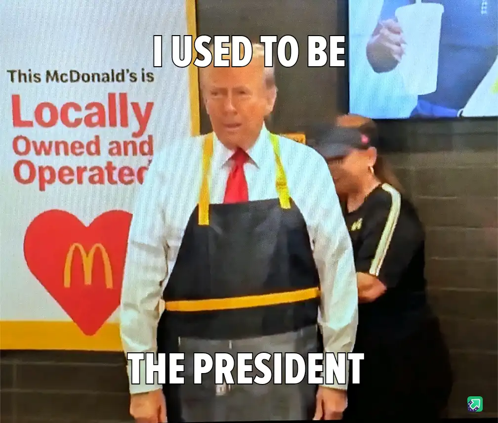 A man in a McDonald's employee apron stands in front of a sign that reads 'This McDonald's is Locally Owned and Operated'…