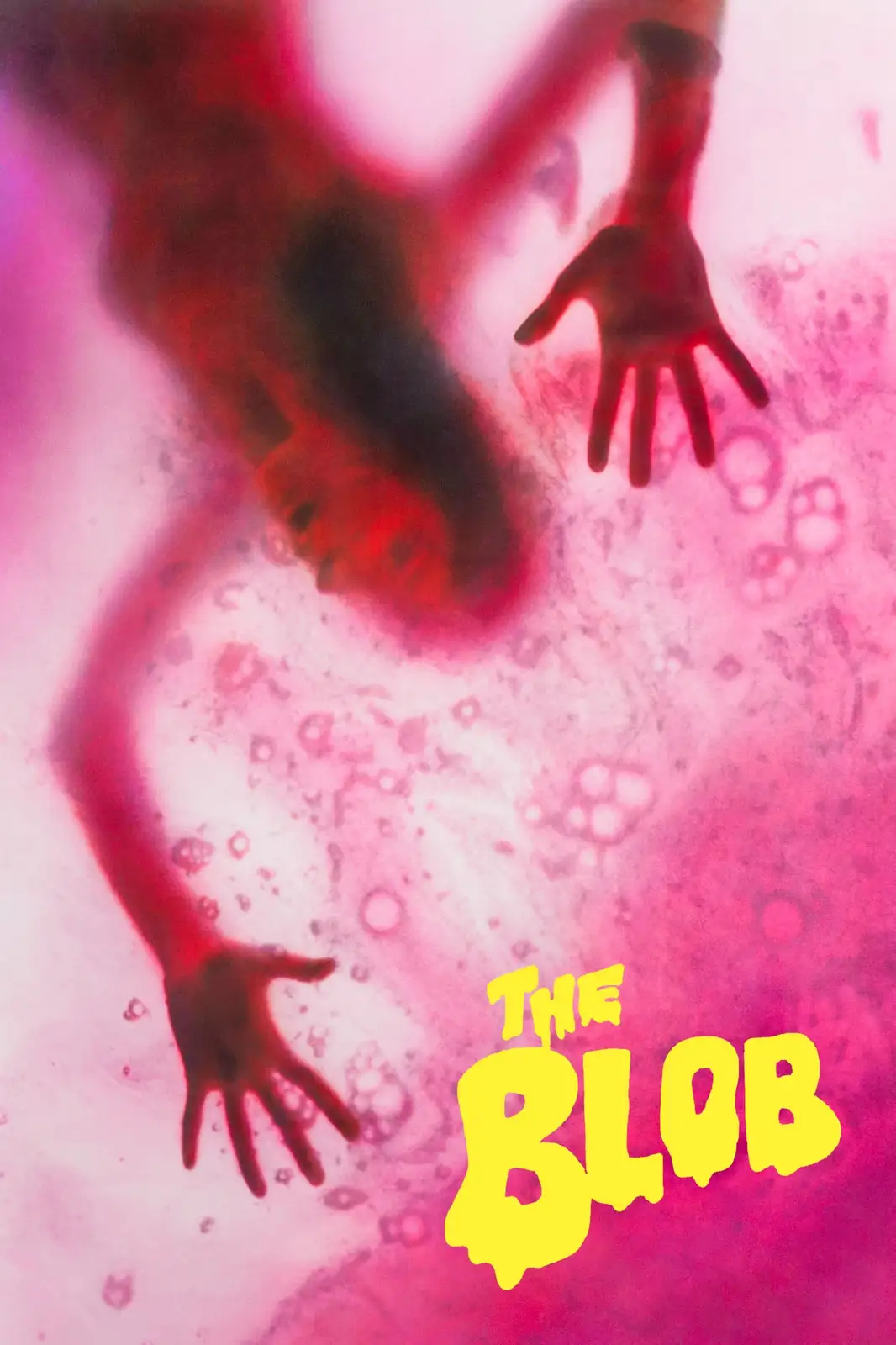 A blurry, red-tinged image shows a human figure with arms outstretched, seemingly submerged or trapped in a pink…