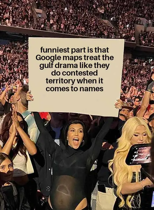 A crowd of people at a concert, with a woman in the foreground holding up a large white sign. The sign reads: 'funniest part…
