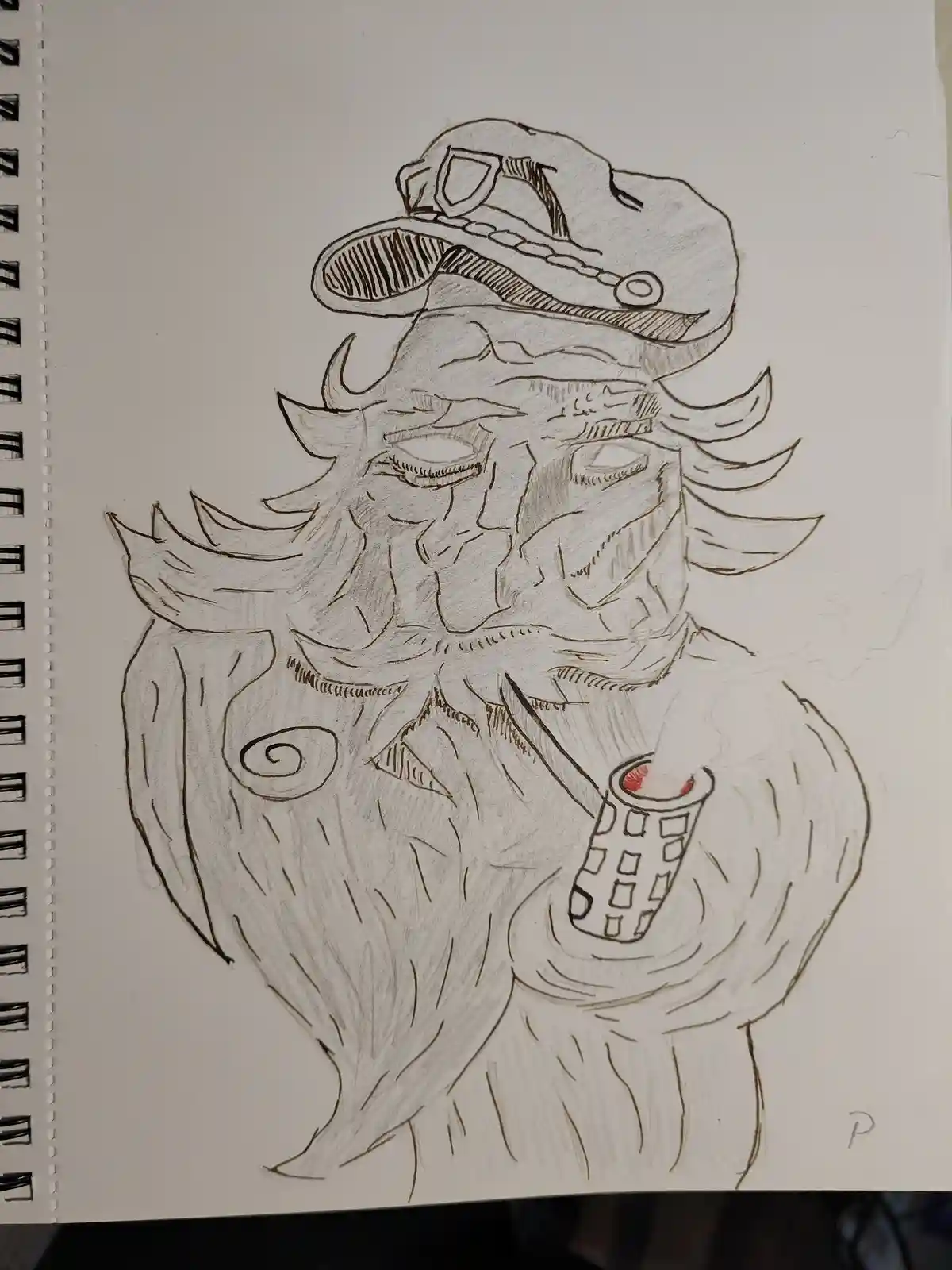 A hand-drawn sketch on spiral-bound notebook paper shows a stylized, bearded man with horns, wearing a hat with goggles on…