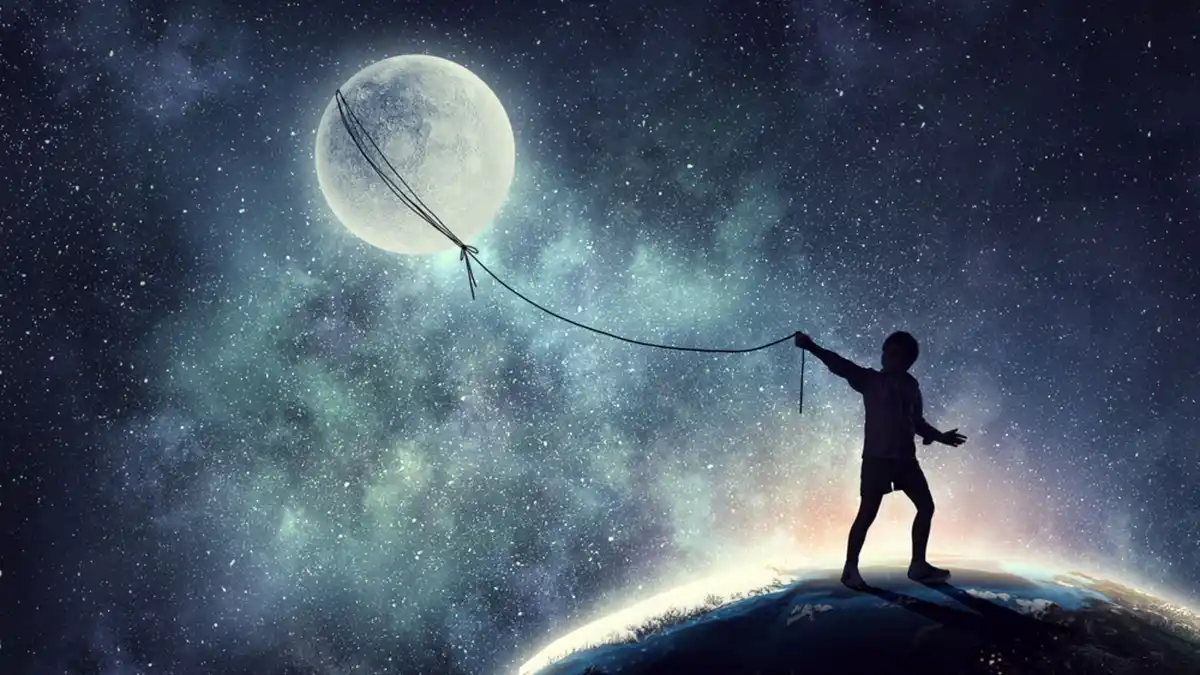 A silhouette of a child stands on the edge of a planet, holding a string tied to a large moon floating in a starry sky. The…