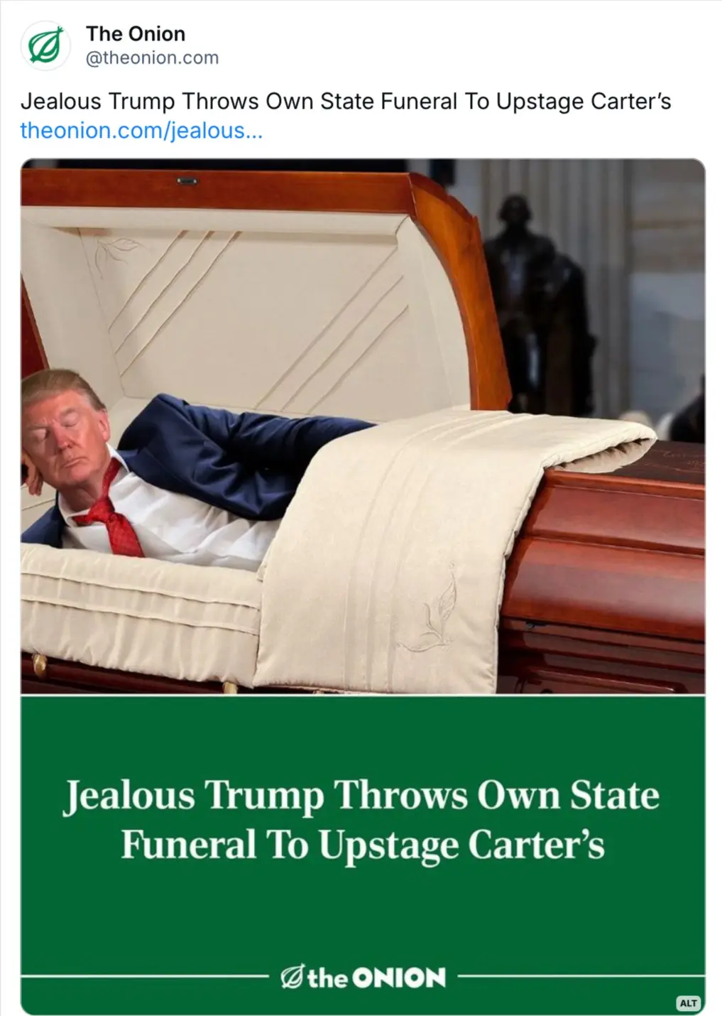 A man resembling Donald Trump lies in a polished wooden casket with a cream-colored interior and blanket, eyes closed as if…