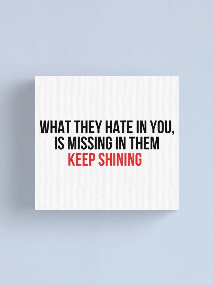 A white square canvas with bold black and red text reads 'WHAT THEY HATE IN YOU, IS MISSING IN THEM KEEP SHINING' against a…
