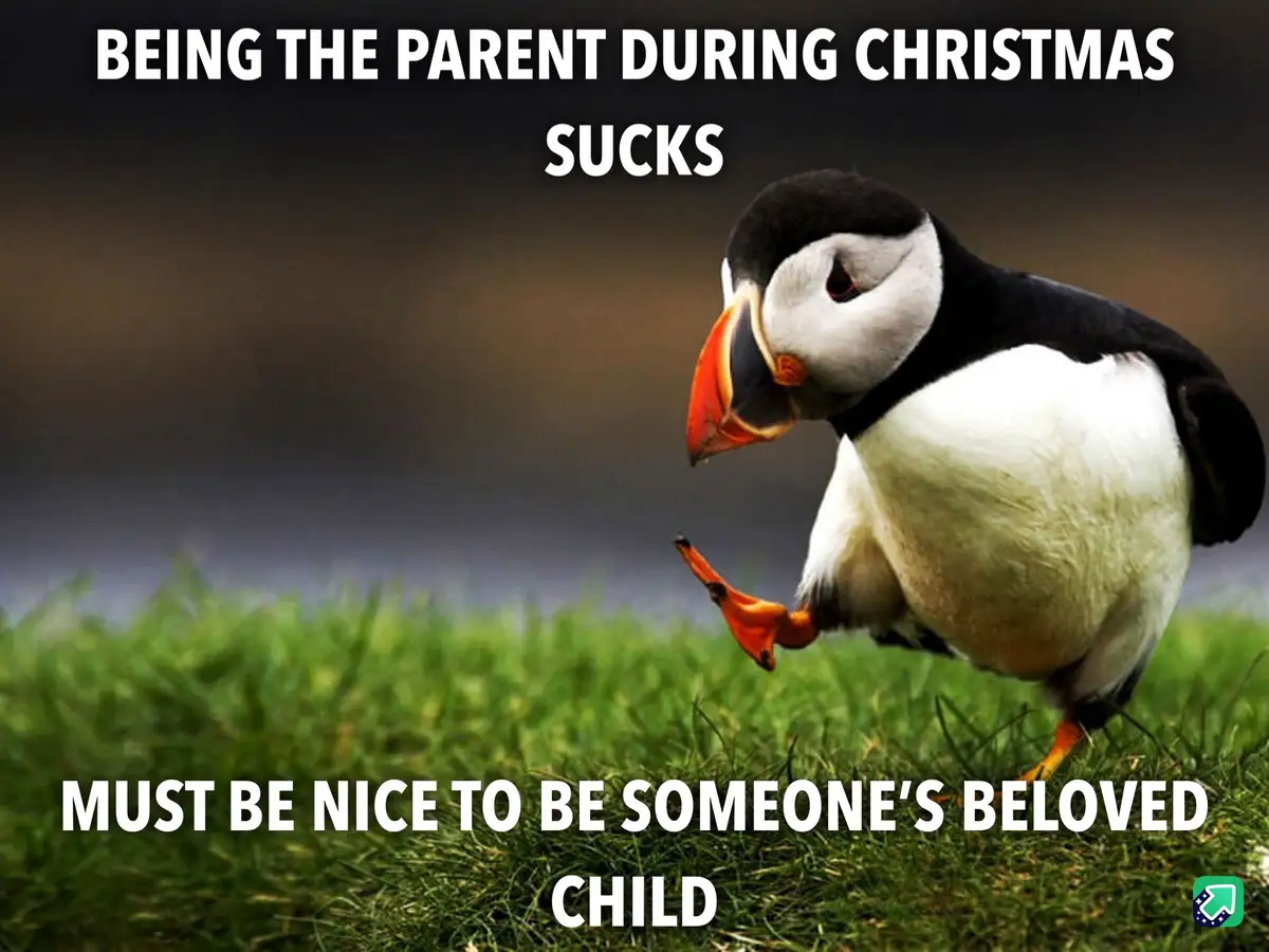 A photograph of a puffin standing on green grass with a blurred background, looking down with a sad or resigned expression…