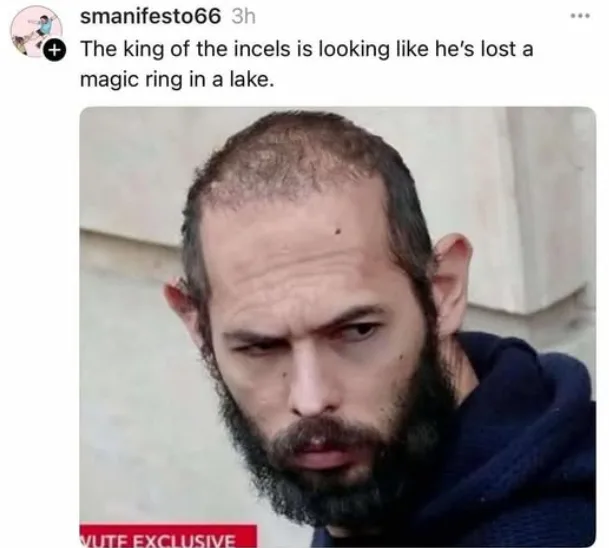 A close-up photo of a man with a receding hairline, a full beard, and a deeply frustrated or annoyed expression, looking…
