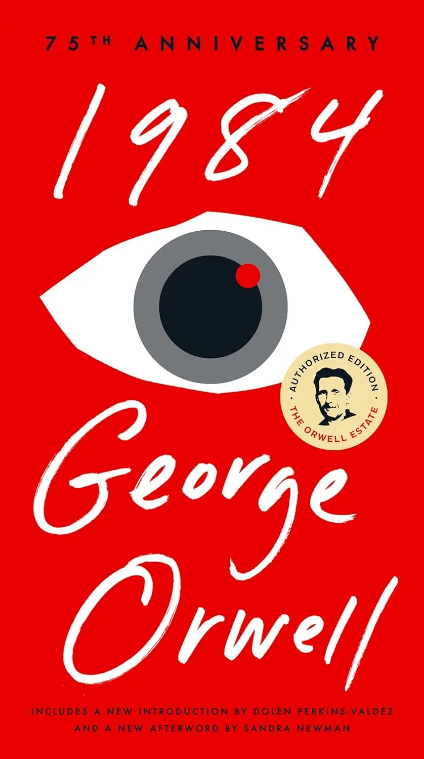 The image displays the cover of George Orwell's novel '1984', featuring a large, stylized white eye with a red dot on its…