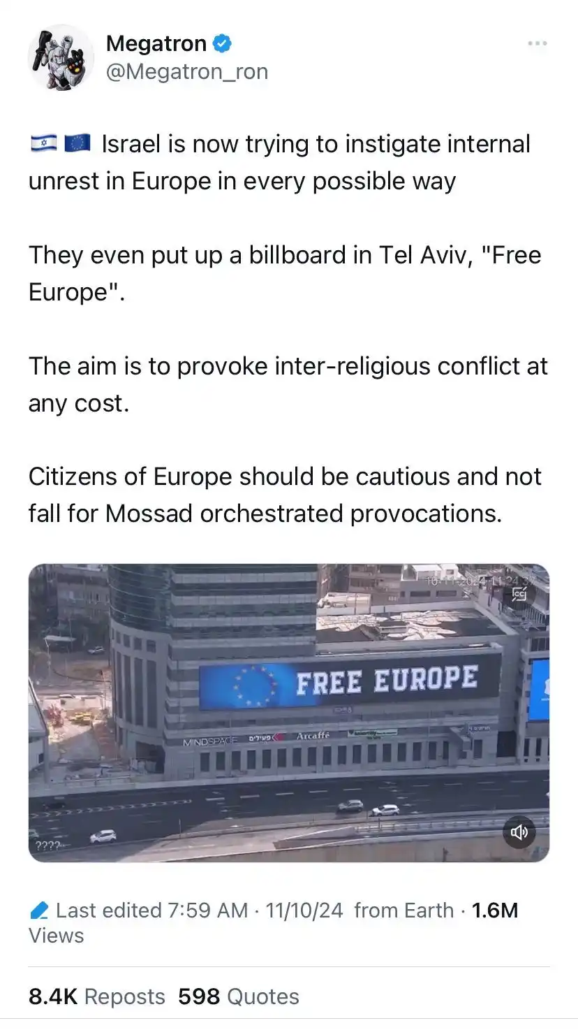 A screenshot of a tweet by user Megatron_ron showing a photo of a large billboard on a Tel Aviv building. The billboard…