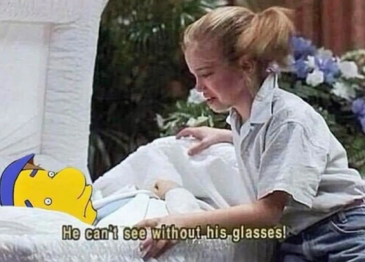 A young woman in a white shirt and jeans leans over a white casket, visibly crying with her hand on the lid. Superimposed on…