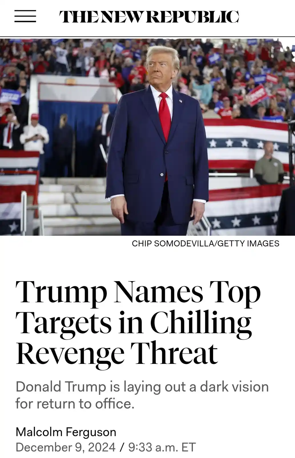 The image shows Donald Trump standing in front of a crowd at a rally, wearing a dark blue suit and red tie, with American…
