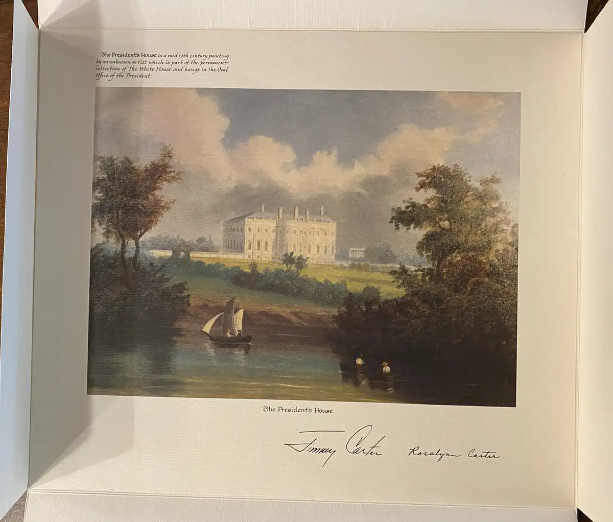 A framed painting titled 'The President's House' depicts a large white mansion on a hill overlooking a river with boats and…