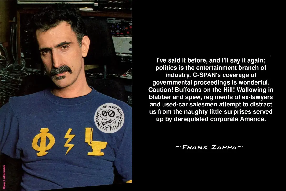 A man with dark hair and a mustache wearing a blue t-shirt with yellow symbols and a 'CENSORED' patch looks at the camera…