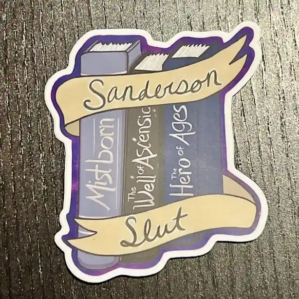 A sticker depicting three fantasy book spines labeled 'Mistborn', 'The Well of Ascension', and 'The Hero of Ages', with the…
