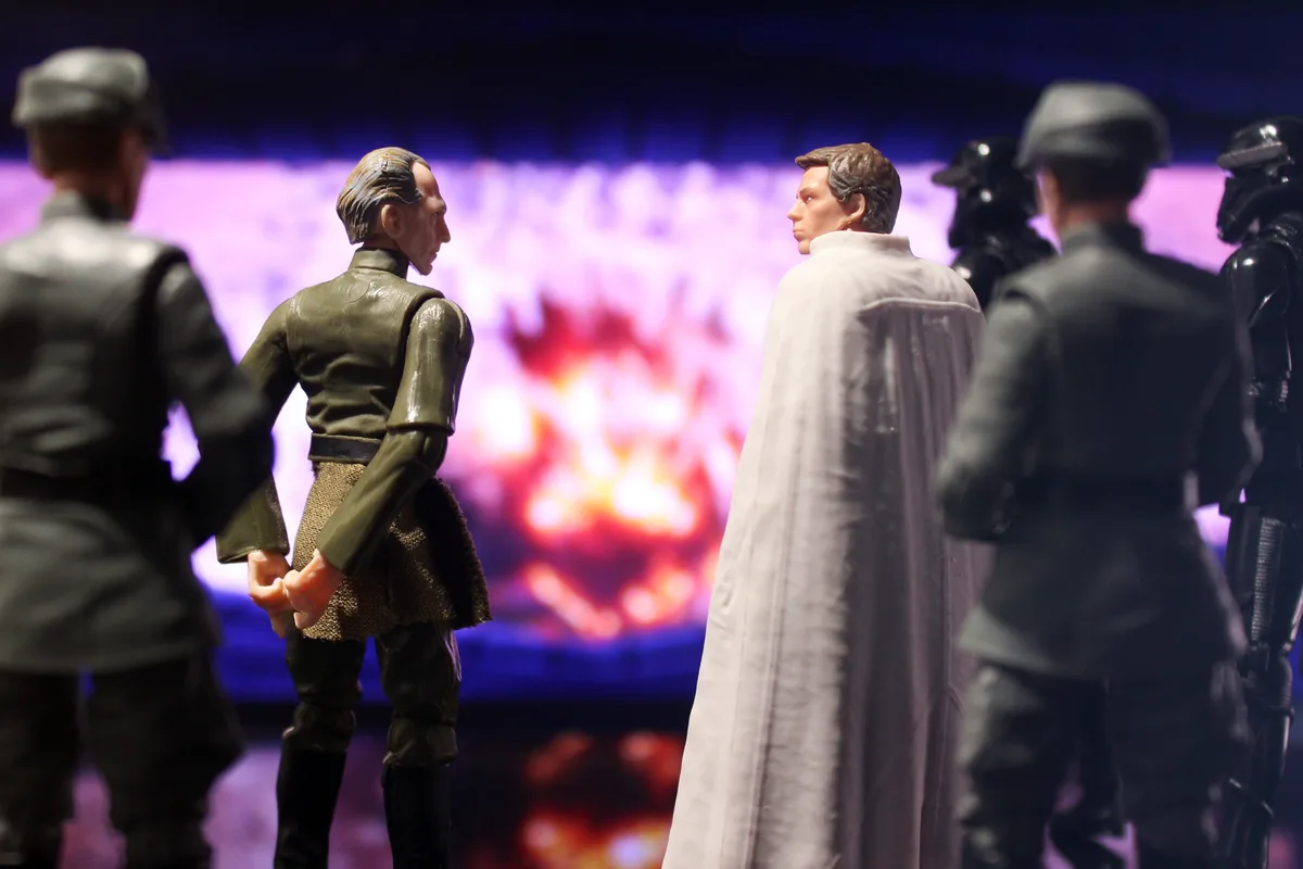 A photo of Star Wars action figures, including Palpatine and Luke Skywalker facing each other with stormtroopers and Darth…