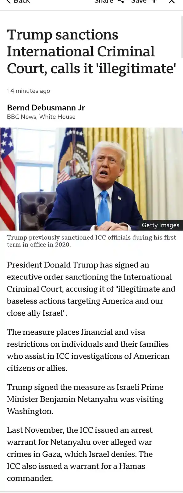 A screenshot of a BBC News article shows a photo of Donald Trump seated at a desk in an official setting, with American…