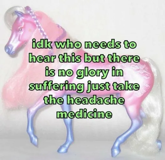 A pink and blue plastic toy unicorn with a white mane and tail stands against a plain background. Overlaid green text reads…