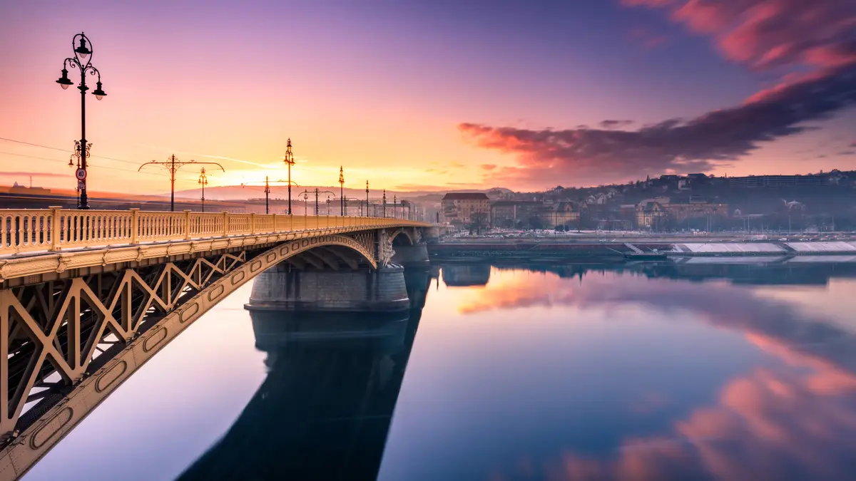 Set sun on the Margaret Bridge, a wrought-iron link between Buda's west and Pest's east banks in Budapest. This 1876 bridge…