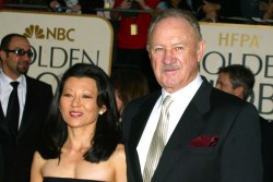 A man and woman stand together at a red carpet event, likely the Golden Globes, with 'NBC GOLDEN GLOBES' and 'HFPA' logos…