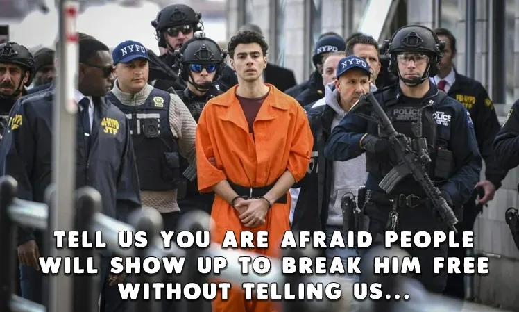 A young man in an orange prison jumpsuit stands center-frame surrounded by heavily armed NYPD officers in tactical gear. The…