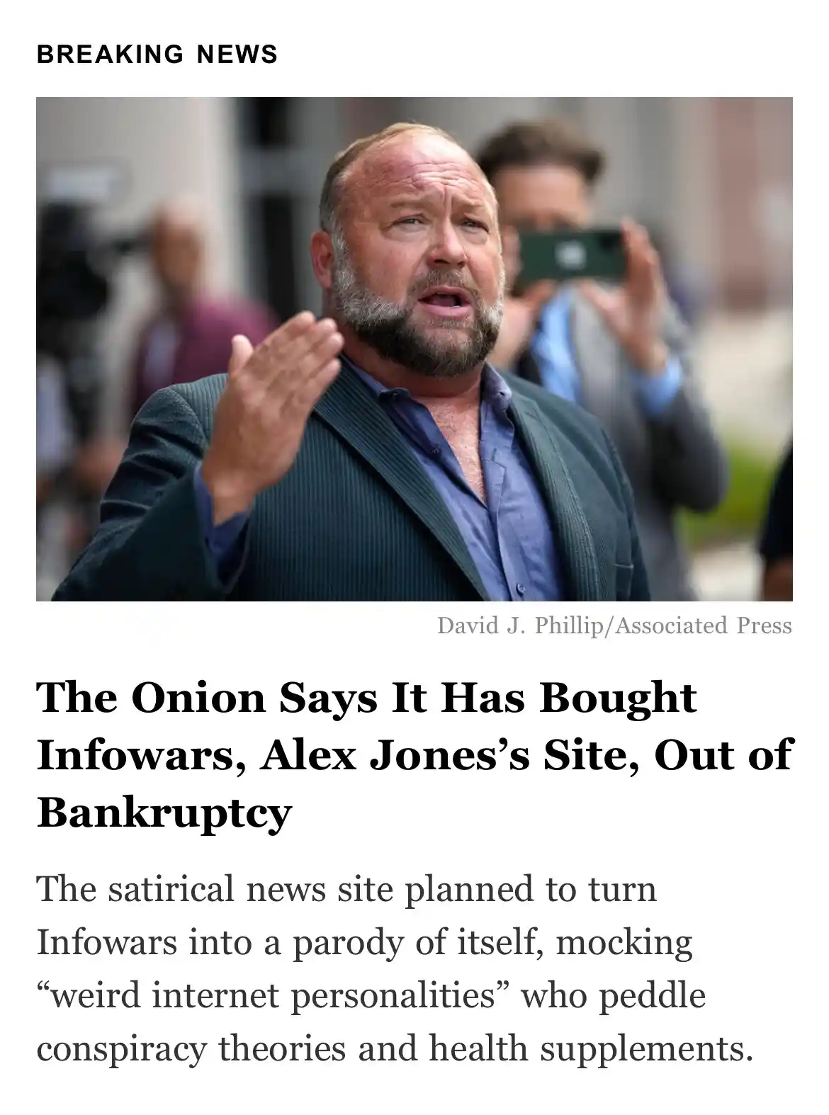 A man with a beard and dark suit is shown in a news photo, looking shocked with his hand raised. The image is overlaid with…