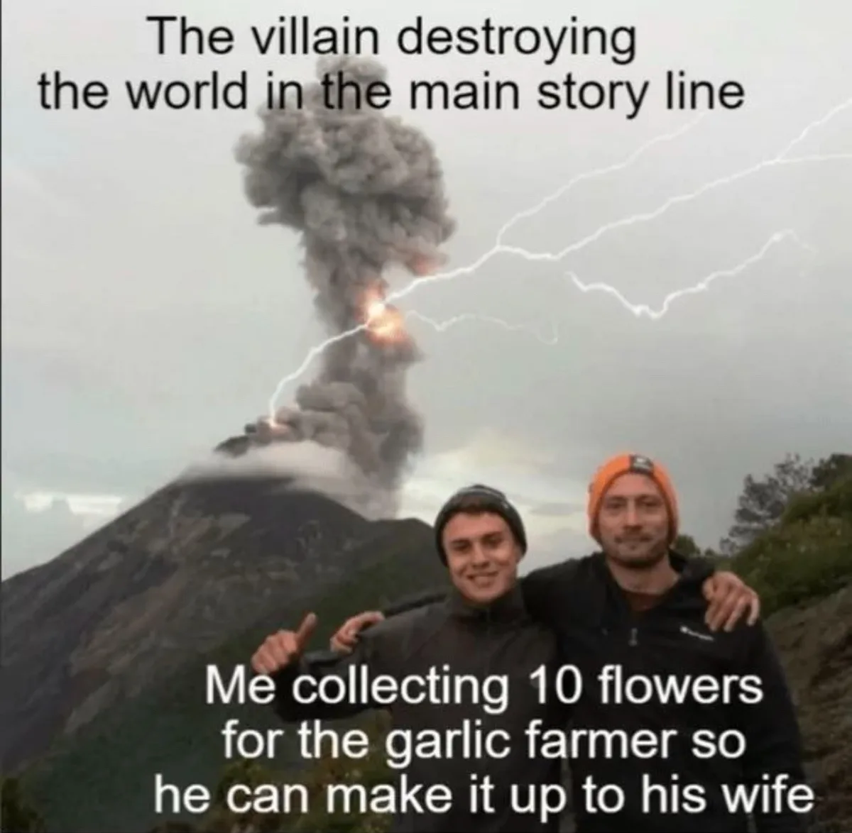 Two smiling men pose for a photo in front of a volcano erupting with smoke and lightning. The top text reads 'The villain…