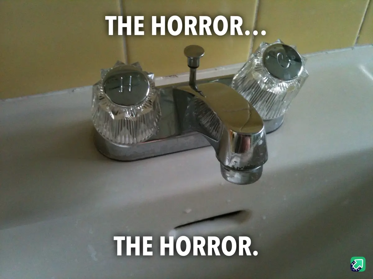 A close-up photo of a chrome bathroom faucet with two crystal-style handles, set against a yellow tiled wall and white sink…