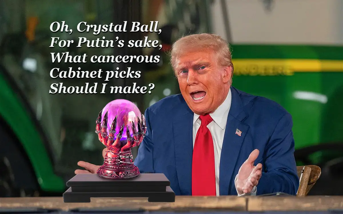 A man in a blue suit and red tie sits at a table, gesturing with both hands as if asking a question. In front of him is a…