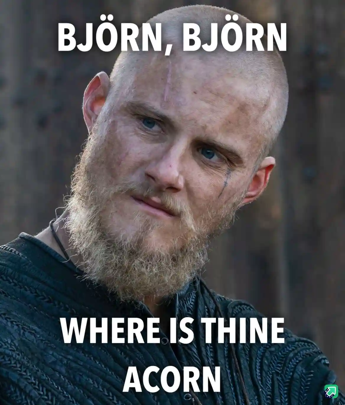 A close-up of a bald, bearded man with blue eyes and a stern expression, wearing a dark textured tunic. The overlaid text…