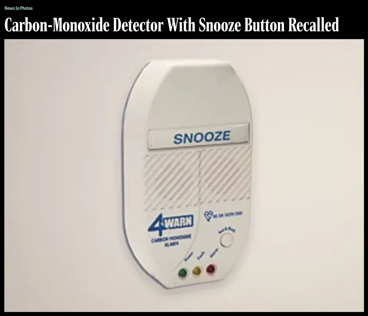 A white 4-WARN carbon monoxide alarm is mounted on a wall, featuring a large 'SNOOZE' button above a speaker grille and…