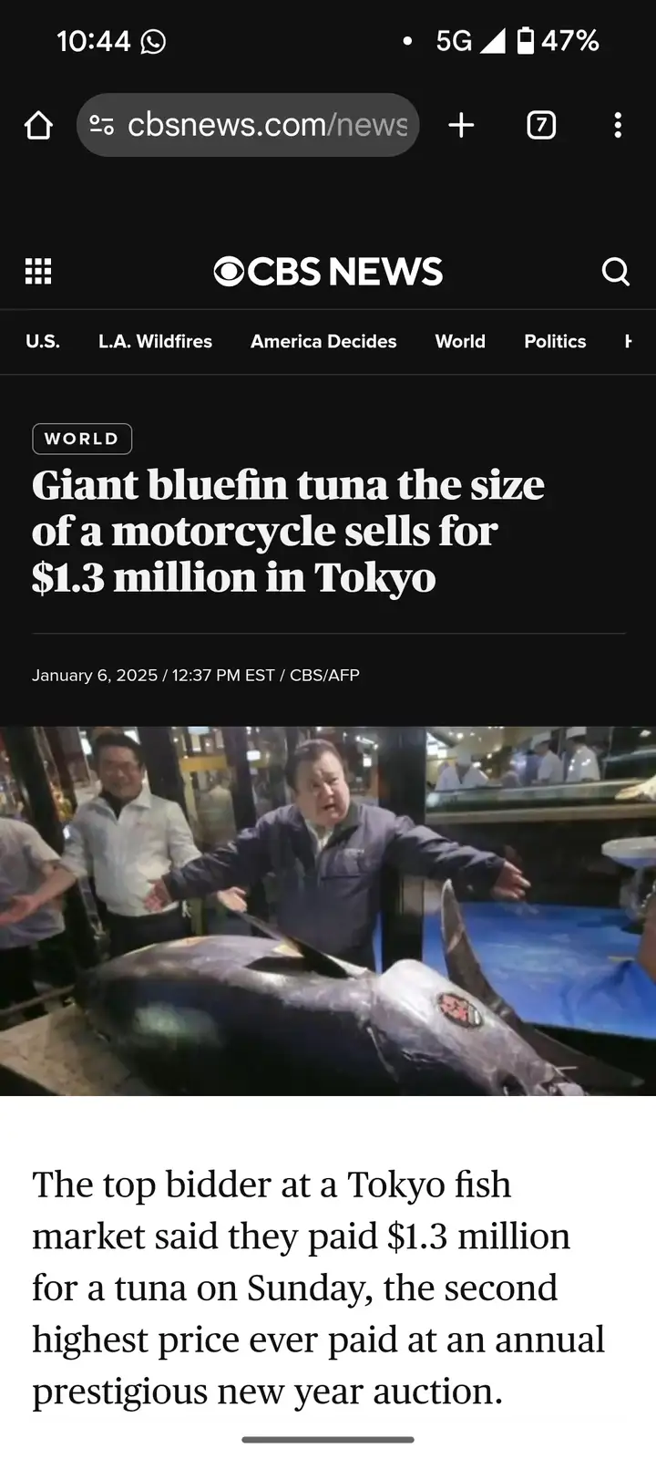 A screenshot of a CBS News article shows a large bluefin tuna on display at a Tokyo fish market, with a man gesturing toward…