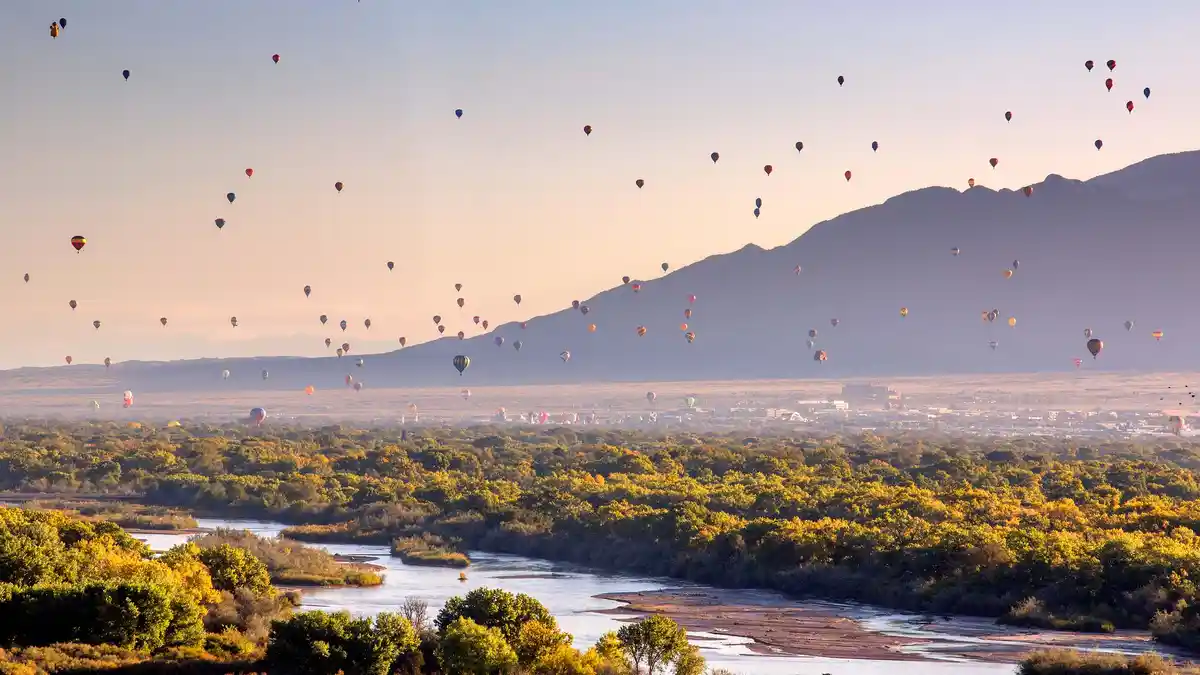 Albuquerque's International Balloon Fiesta whisks enthusiasts away as hot air balloons of vibrant colors and unique shapes…