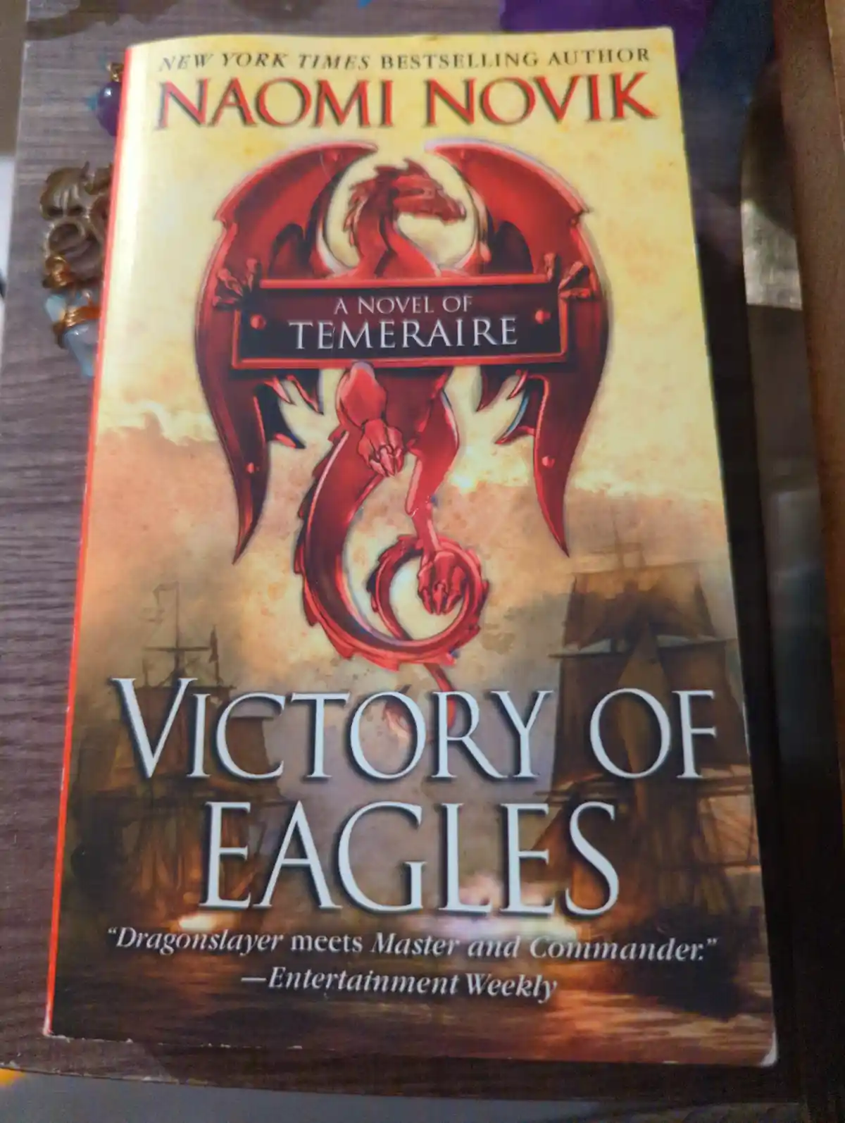 A close-up photo of the book cover for 'Victory of Eagles' by Naomi Novik, featuring a prominent red dragon illustration and…
