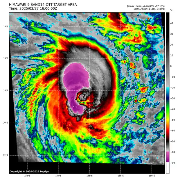 A satellite image from Himawari-9 shows a powerful tropical cyclone with a distinct purple eye surrounded by intense red and…