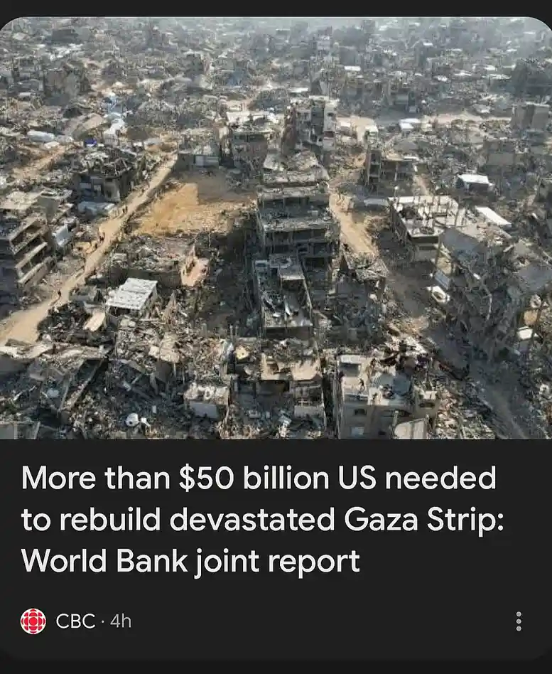 An aerial photograph shows a wide expanse of urban ruins, with collapsed buildings, rubble, and debris covering what was…