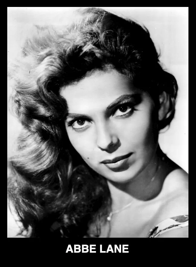 A black-and-white portrait of a woman with voluminous, styled hair and a direct, intense gaze. The text 'ABBE LANE' is…