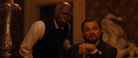 A still from the movie 'The Wolf of Wall Street' shows Leonardo DiCaprio seated and looking shocked, while a Black man in a…