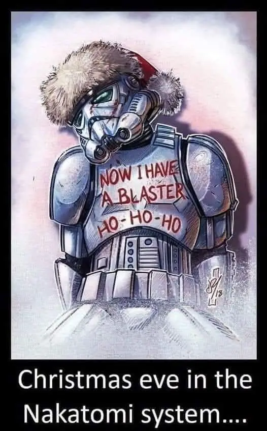 A Star Wars stormtrooper wearing a Santa hat with a fluffy pom-pom stands in a snowy scene, with red text on his chest…