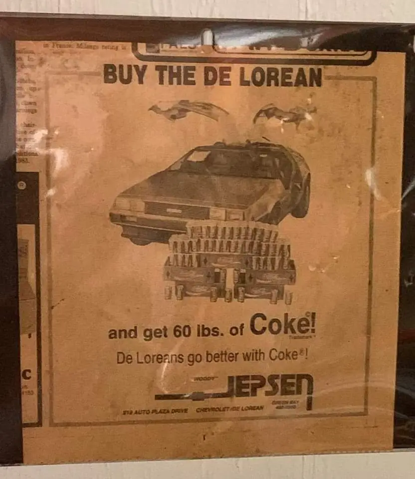 A vintage, sepia-toned advertisement poster for a DeLorean car, featuring an image of the iconic car with a stack of…