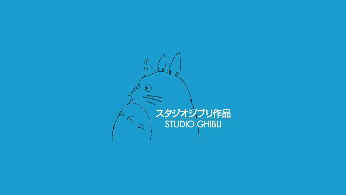 A minimalist line drawing of the character Totoro from Studio Ghibli, with a smaller Totoro perched on its head, set against…