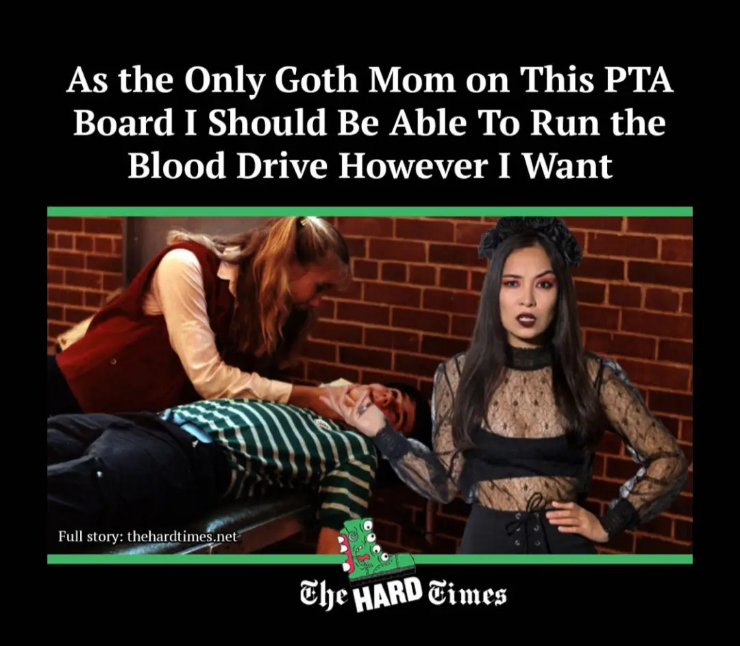 A woman in gothic attire stands with hands on hips while another woman in a red vest administers a blood draw to a man lying…