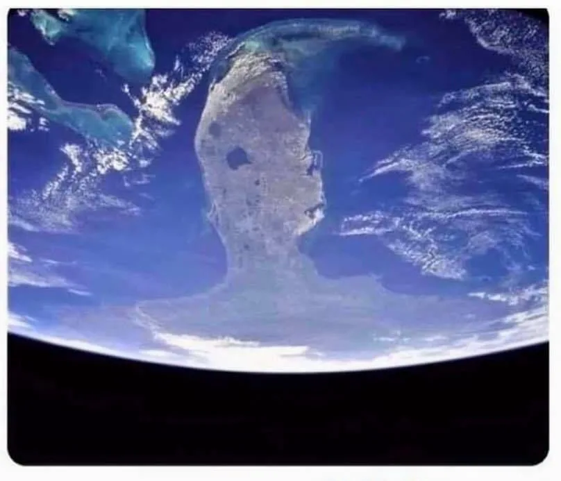 a satellite image of earth from space shows a landmass in the caribbean that resembles a human face in profile, with the…