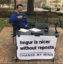 A man sits at a small outdoor desk with a sign that reads 'Imgr is nicer without reposts CHANGE MY MIND'. He holds a mug and…