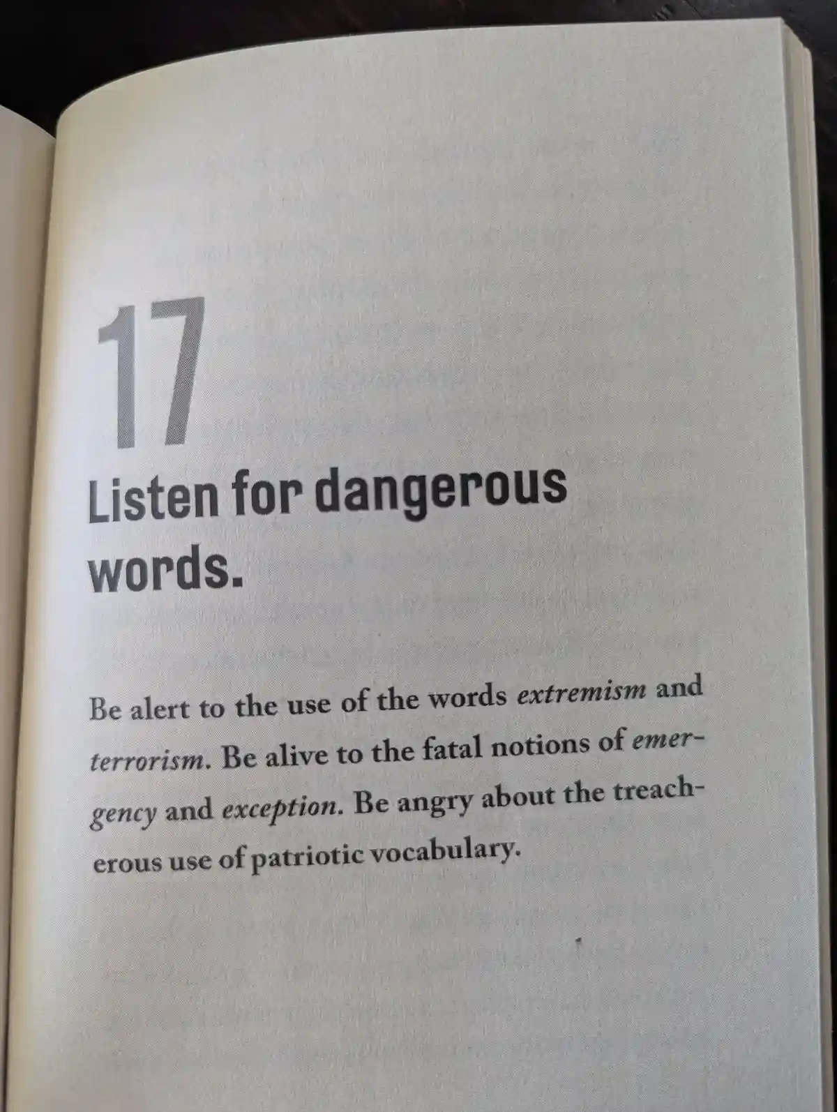 A close-up photo of a book page, numbered 17, with the heading 'Listen for dangerous words.' The text advises being alert to…