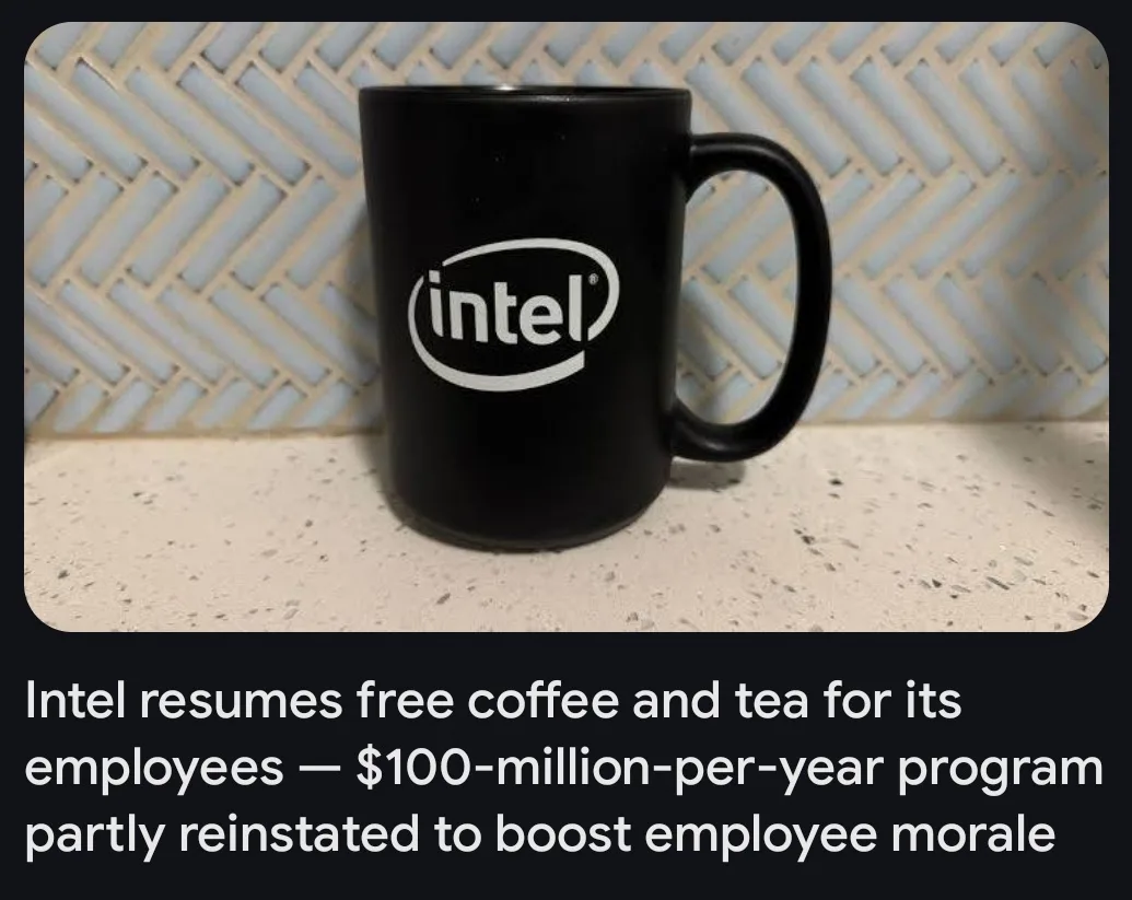 A black ceramic mug with the white Intel logo sits on a speckled countertop against a herringbone-patterned tile backsplash…